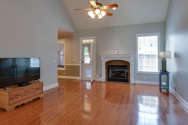 3024 Brookside Path, Murfreesboro, TN 37128 - unfurnished living room with ceiling fan, wood finished floors, healthy amount of natural light, a tiled fireplace, and high vaulted ceiling