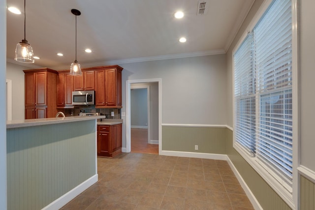 3024 Brookside Path, Murfreesboro, TN 37128 - kitchen featuring stainless steel microwave, light countertops, decorative light fixtures, brown cabinets, and crown molding