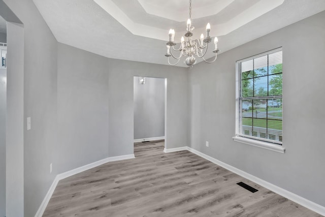 6109 Ebenezer Rd, Greenbrier, TN 37073 - empty room featuring wood finished floors, a chandelier, baseboards, and a tray ceiling