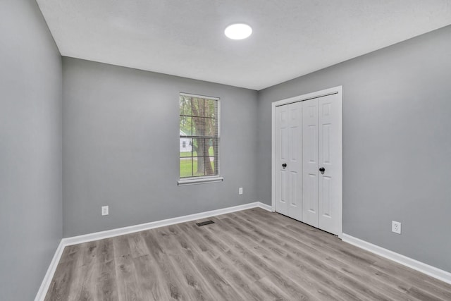6109 Ebenezer Rd, Greenbrier, TN 37073 - unfurnished bedroom with wood finished floors, baseboards, and a closet