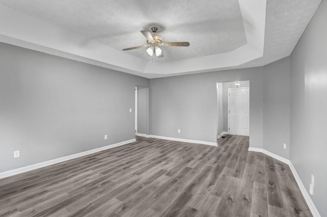 6109 Ebenezer Rd, Greenbrier, TN 37073 - unfurnished room featuring a textured ceiling, a raised ceiling, a ceiling fan, wood finished floors, and baseboards