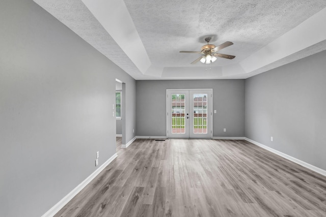 6109 Ebenezer Rd, Greenbrier, TN 37073 - empty room with a textured ceiling, a tray ceiling, ceiling fan, wood finished floors, and baseboards