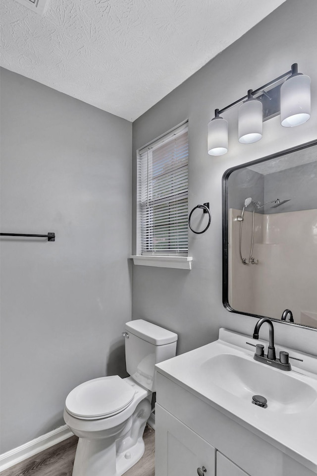 6109 Ebenezer Rd, Greenbrier, TN 37073 - bathroom featuring wood finished floors, a shower, vanity, toilet, and a textured ceiling
