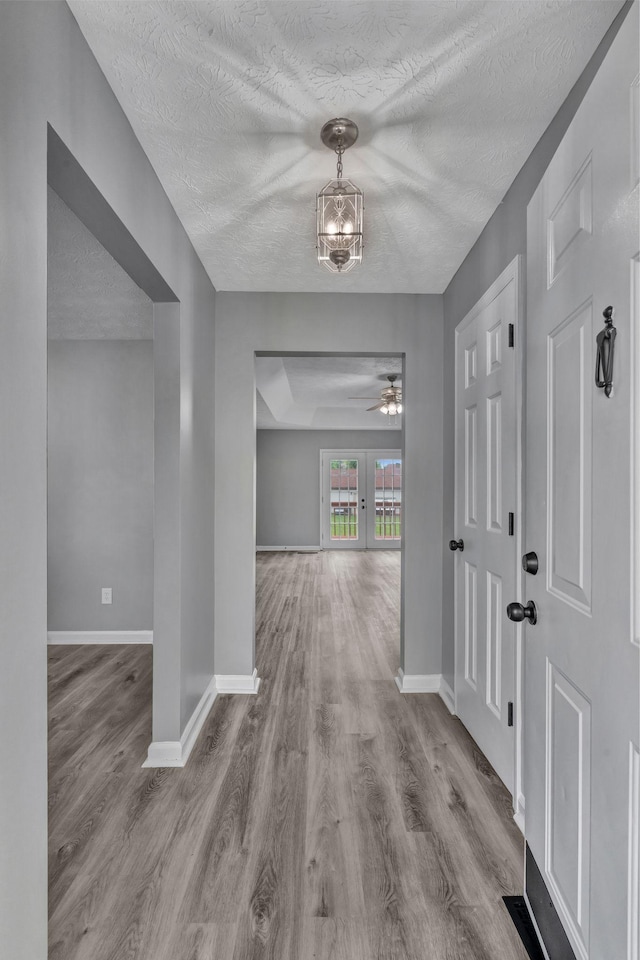 6109 Ebenezer Rd, Greenbrier, TN 37073 - entryway with wood finished floors, a textured ceiling, baseboards, french doors, and ceiling fan