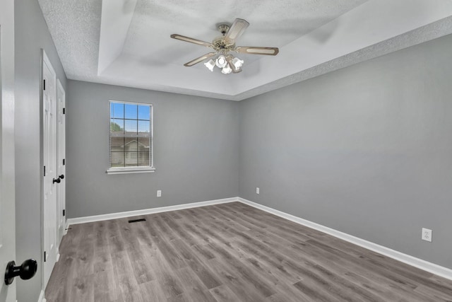 6109 Ebenezer Rd, Greenbrier, TN 37073 - spare room featuring a raised ceiling, a textured ceiling, wood finished floors, and ceiling fan