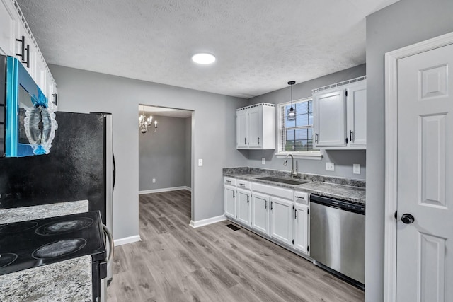 6109 Ebenezer Rd, Greenbrier, TN 37073 - kitchen with stainless steel appliances, a sink, a textured ceiling, a chandelier, and white cabinets