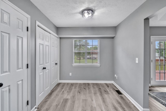 6109 Ebenezer Rd, Greenbrier, TN 37073 - unfurnished bedroom with light wood-style floors, a textured ceiling, and baseboards