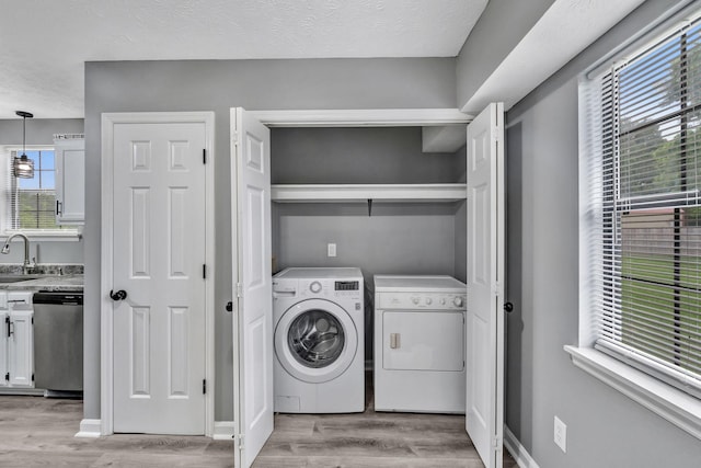 6109 Ebenezer Rd, Greenbrier, TN 37073 - laundry area with washing machine and clothes dryer, light wood-type flooring, and healthy amount of natural light