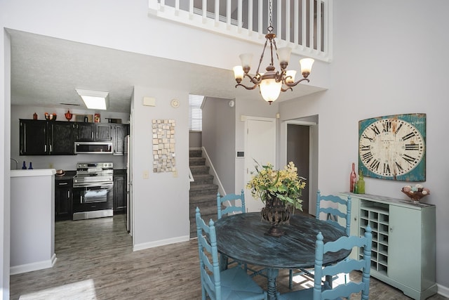 5943 Colchester Dr, Hermitage, TN 37076 - dining area with stairway, a chandelier, baseboards, wood finished floors, and a high ceiling