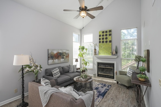 5943 Colchester Dr, Hermitage, TN 37076 - living room with wood finished floors, a glass covered fireplace, ceiling fan, plenty of natural light, and high vaulted ceiling