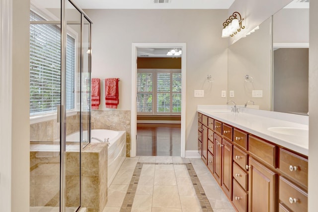 221 Antebellum Ln, Mount Juliet, TN 37122 - bathroom featuring tile patterned floors, double vanity, a garden tub, a shower stall, and baseboards