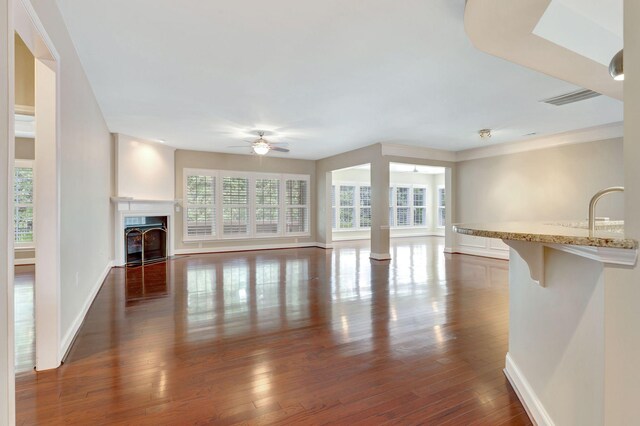 221 Antebellum Ln, Mount Juliet, TN 37122 - unfurnished living room featuring ceiling fan, dark wood-style flooring, baseboards, and a fireplace with flush hearth