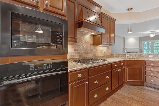 221 Antebellum Ln, Mount Juliet, TN 37122 - kitchen with black appliances, premium range hood, a sink, and brown cabinetry