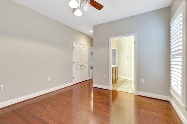 221 Antebellum Ln, Mount Juliet, TN 37122 - unfurnished bedroom featuring wood finished floors, multiple windows, ensuite bath, and baseboards