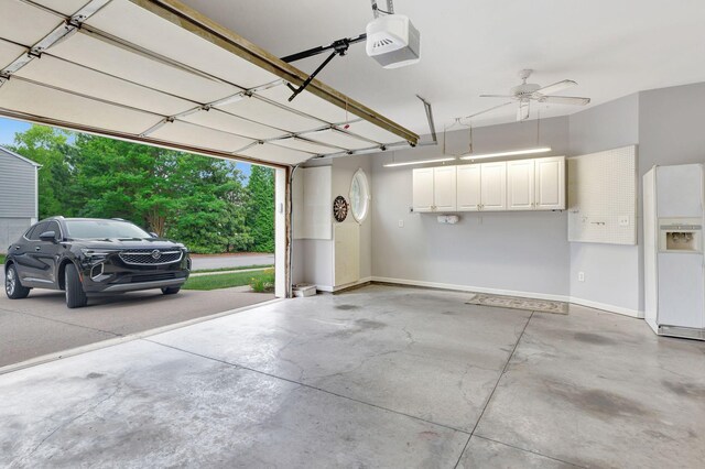 221 Antebellum Ln, Mount Juliet, TN 37122 - garage featuring white refrigerator with ice dispenser, a garage door opener, baseboards, and ceiling fan