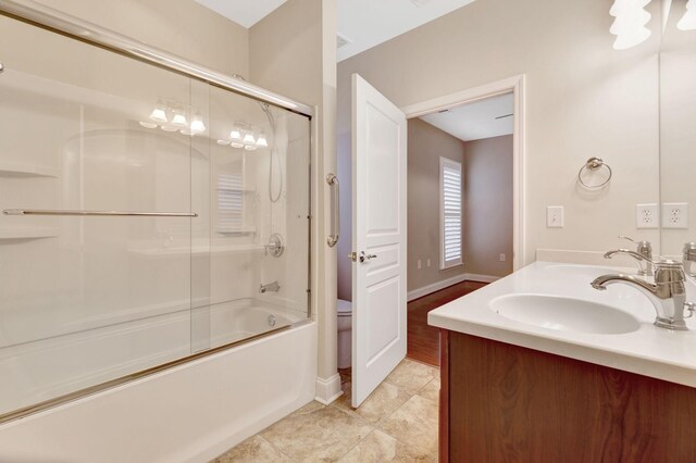 221 Antebellum Ln, Mount Juliet, TN 37122 - bathroom featuring toilet, baseboards, double vanity, and shower / bath combination with glass door