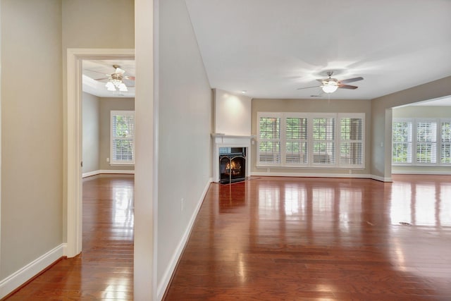 221 Antebellum Ln, Mount Juliet, TN 37122 - unfurnished living room featuring ceiling fan, hardwood / wood-style flooring, a fireplace with flush hearth, and baseboards