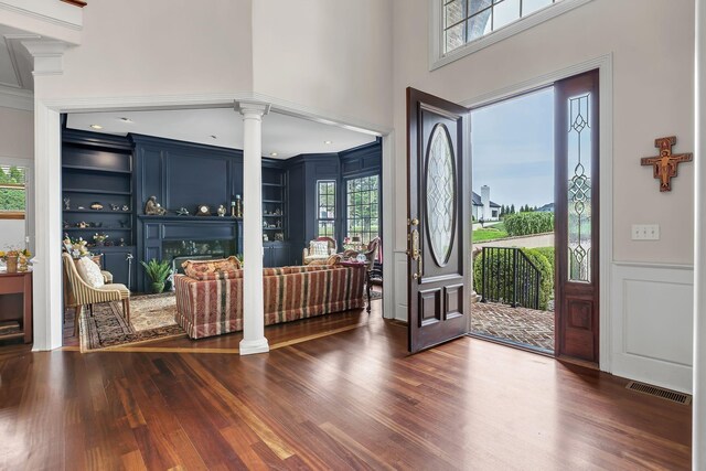 9619 Deer Track Ct, Brentwood, TN 37027 - foyer featuring ornate columns, dark wood-style floors, plenty of natural light, a decorative wall, and a high ceiling