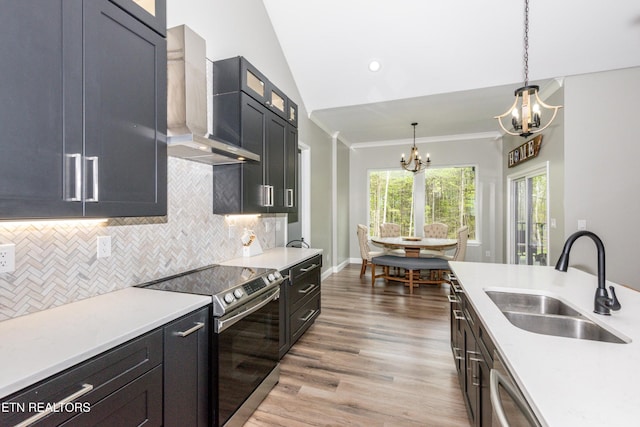 355 Shadows Lawn Dr, Athens, TN 37303 - kitchen featuring stainless steel appliances, a sink, a chandelier, wall chimney exhaust hood, and light wood finished floors