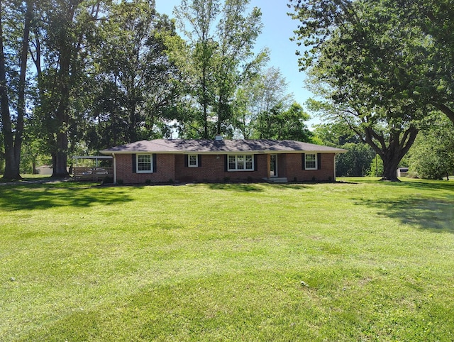 1305 Ellington Dr, Lafayette, TN 37083 - back of house with a lawn, brick siding, and a carport