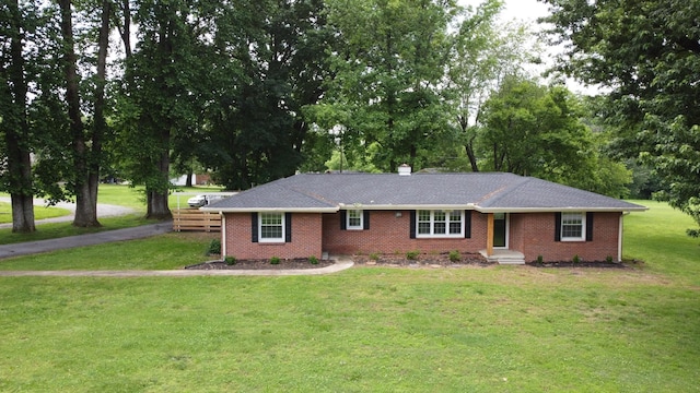 1305 Ellington Dr, Lafayette, TN 37083 - ranch-style home with brick siding, a front lawn, and view of scattered trees