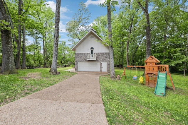 503 Dawn Pl, Lebanon, TN 37087 - view of home's exterior with driveway, a yard, stone siding, a playground, and view of scattered trees