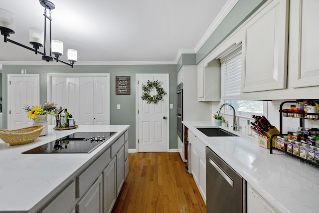 503 Dawn Pl, Lebanon, TN 37087 - kitchen with appliances with stainless steel finishes, a sink, ornamental molding, wood finished floors, and white cabinets