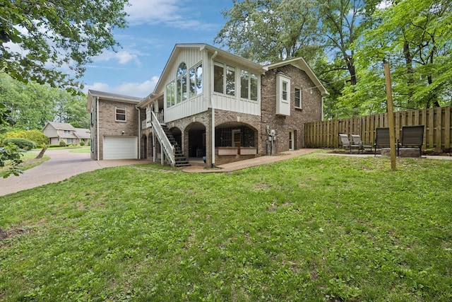 503 Dawn Pl, Lebanon, TN 37087 - rear view of house with a garage, concrete driveway, stairway, and brick siding