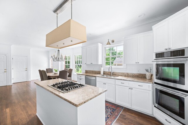 5313 Curlybark Pl, Brentwood, TN 37027 - kitchen with appliances with stainless steel finishes, a sink, dark wood-style flooring, white cabinetry, and a center island