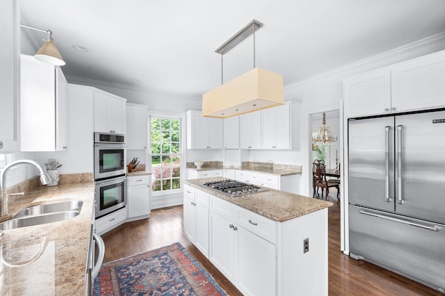 5313 Curlybark Pl, Brentwood, TN 37027 - kitchen featuring stainless steel appliances, a sink, ornamental molding, a center island, and dark wood finished floors