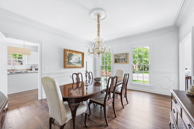 5313 Curlybark Pl, Brentwood, TN 37027 - dining space featuring a chandelier, crown molding, wainscoting, dark wood finished floors, and a decorative wall