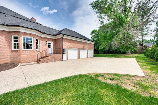 5313 Curlybark Pl, Brentwood, TN 37027 - view of home's exterior featuring brick siding, concrete driveway, an attached garage, a yard, and a chimney