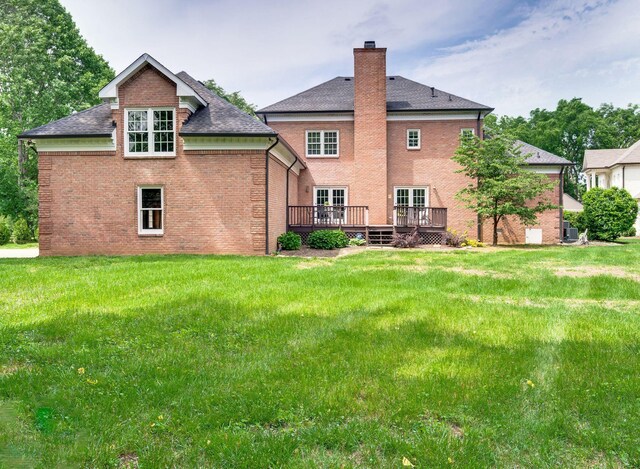 5313 Curlybark Pl, Brentwood, TN 37027 - back of property with a wooden deck, brick siding, a chimney, a lawn, and roof with shingles