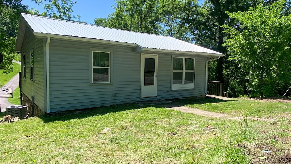 8324 River Road Pike, Nashville, TN 37209 - view of front facade featuring a front lawn, metal roof, and central air condition unit