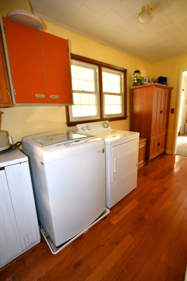 9073 Sherwood Rd, Sherwood, TN 37376 - washroom with cabinet space, washer and clothes dryer, and wood finished floors