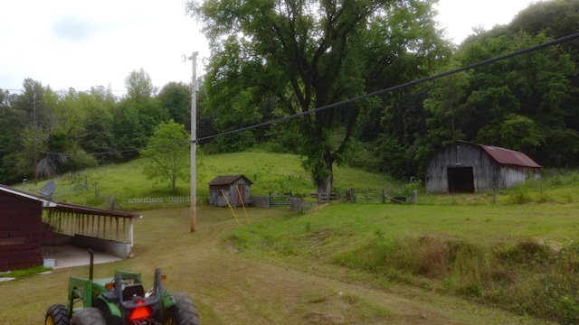 9073 Sherwood Rd, Sherwood, TN 37376 - view of yard with an outdoor structure, a storage shed, fence, and a view of trees