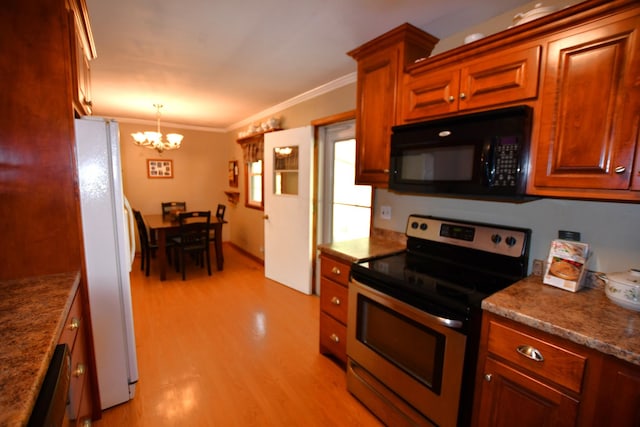 9073 Sherwood Rd, Sherwood, TN 37376 - kitchen with black microwave, stainless steel electric range, freestanding refrigerator, a chandelier, and light wood-type flooring