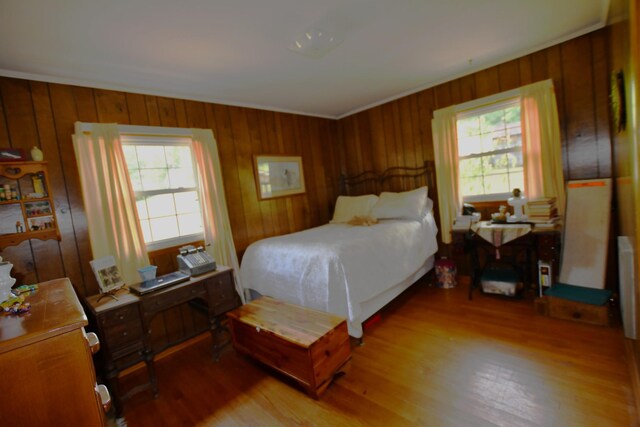 9073 Sherwood Rd, Sherwood, TN 37376 - bedroom with multiple windows, light wood-style floors, wood walls, and crown molding