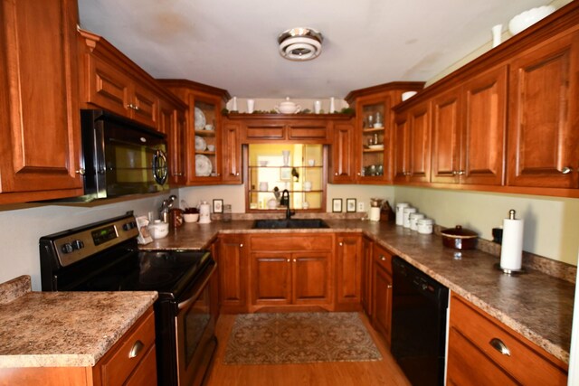 9073 Sherwood Rd, Sherwood, TN 37376 - kitchen with black appliances, a sink, glass insert cabinets, and brown cabinetry