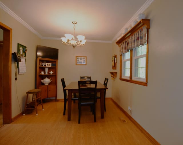 9073 Sherwood Rd, Sherwood, TN 37376 - dining space with light wood-style flooring, a chandelier, crown molding, and baseboards