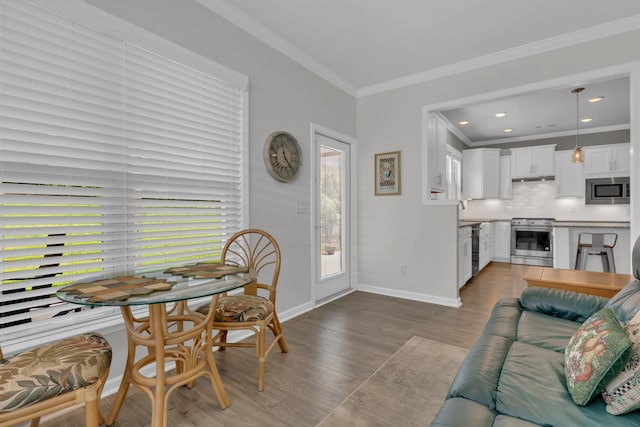 1753 Humphreys Gln, Spring Hill, TN 37174 - living area with wood finished floors, baseboards, crown molding, and recessed lighting
