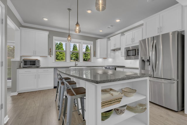1753 Humphreys Gln, Spring Hill, TN 37174 - kitchen featuring appliances with stainless steel finishes, open shelves, white cabinets, crown molding, and dark stone countertops