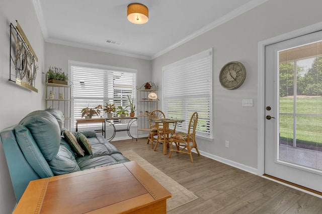 1753 Humphreys Gln, Spring Hill, TN 37174 - living area with light wood-type flooring, crown molding, healthy amount of natural light, and baseboards
