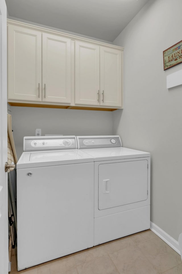 1753 Humphreys Gln, Spring Hill, TN 37174 - clothes washing area with washing machine and clothes dryer, cabinet space, baseboards, and light tile patterned floors