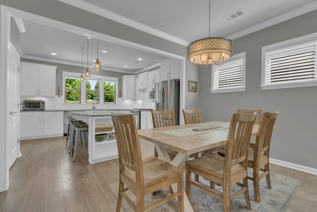 1753 Humphreys Gln, Spring Hill, TN 37174 - dining room featuring crown molding, light wood-style flooring, recessed lighting, and baseboards