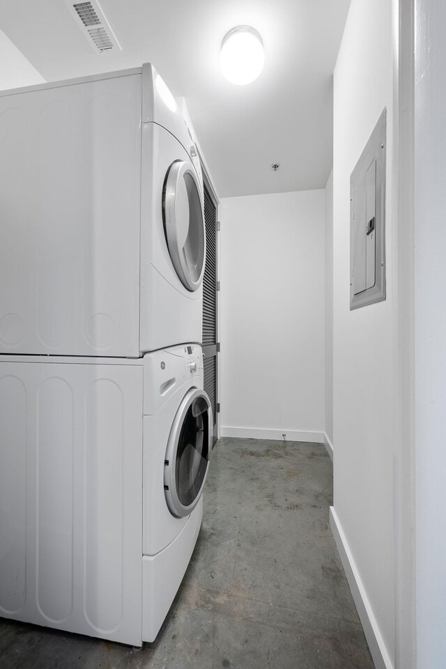 1510 Demonbreun St Unit 712, Nashville, TN 37203 - laundry room featuring stacked washer and clothes dryer, electric panel, and baseboards