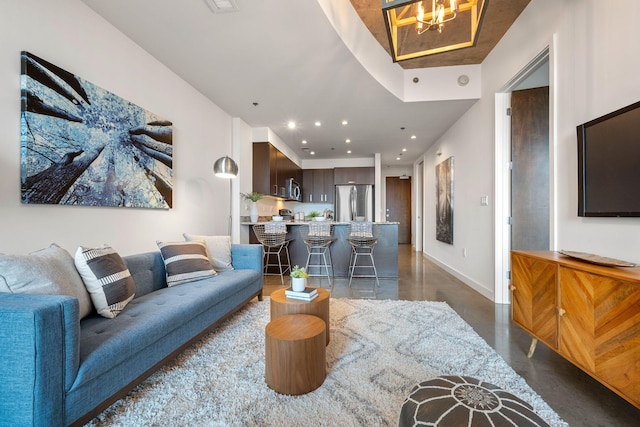 1510 Demonbreun St Unit 712, Nashville, TN 37203 - living room featuring concrete floors, baseboards, a chandelier, and recessed lighting