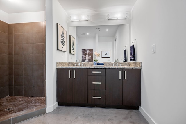 1510 Demonbreun St Unit 712, Nashville, TN 37203 - full bathroom with baseboards, concrete flooring, double vanity, and tiled shower