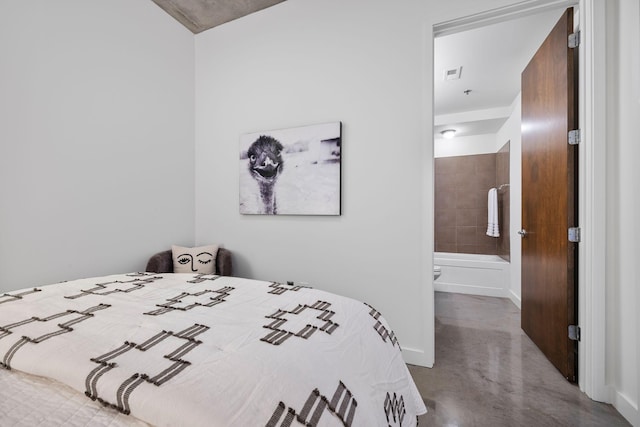 1510 Demonbreun St Unit 712, Nashville, TN 37203 - bedroom featuring concrete floors, connected bathroom, and baseboards