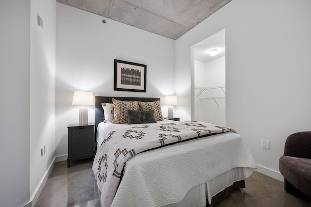 1510 Demonbreun St Unit 712, Nashville, TN 37203 - bedroom featuring baseboards, a spacious closet, and concrete floors